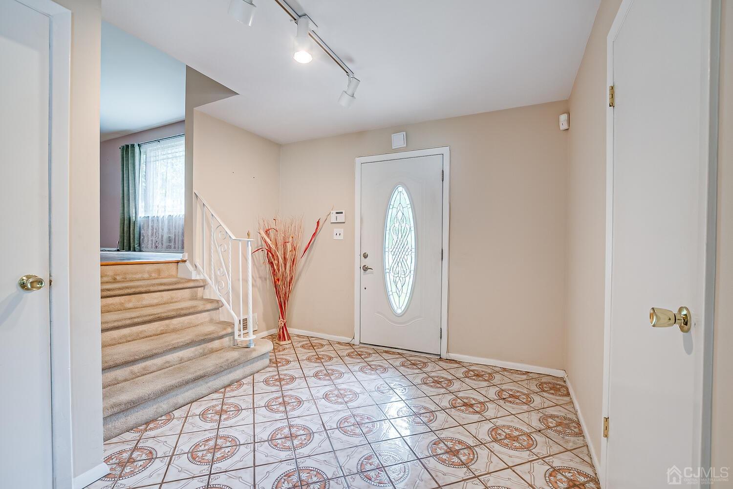 2 Julie Drive Edison, NJ 08820 - Photo 3 of 34 a view of a livingroom with wooden floor and white walls