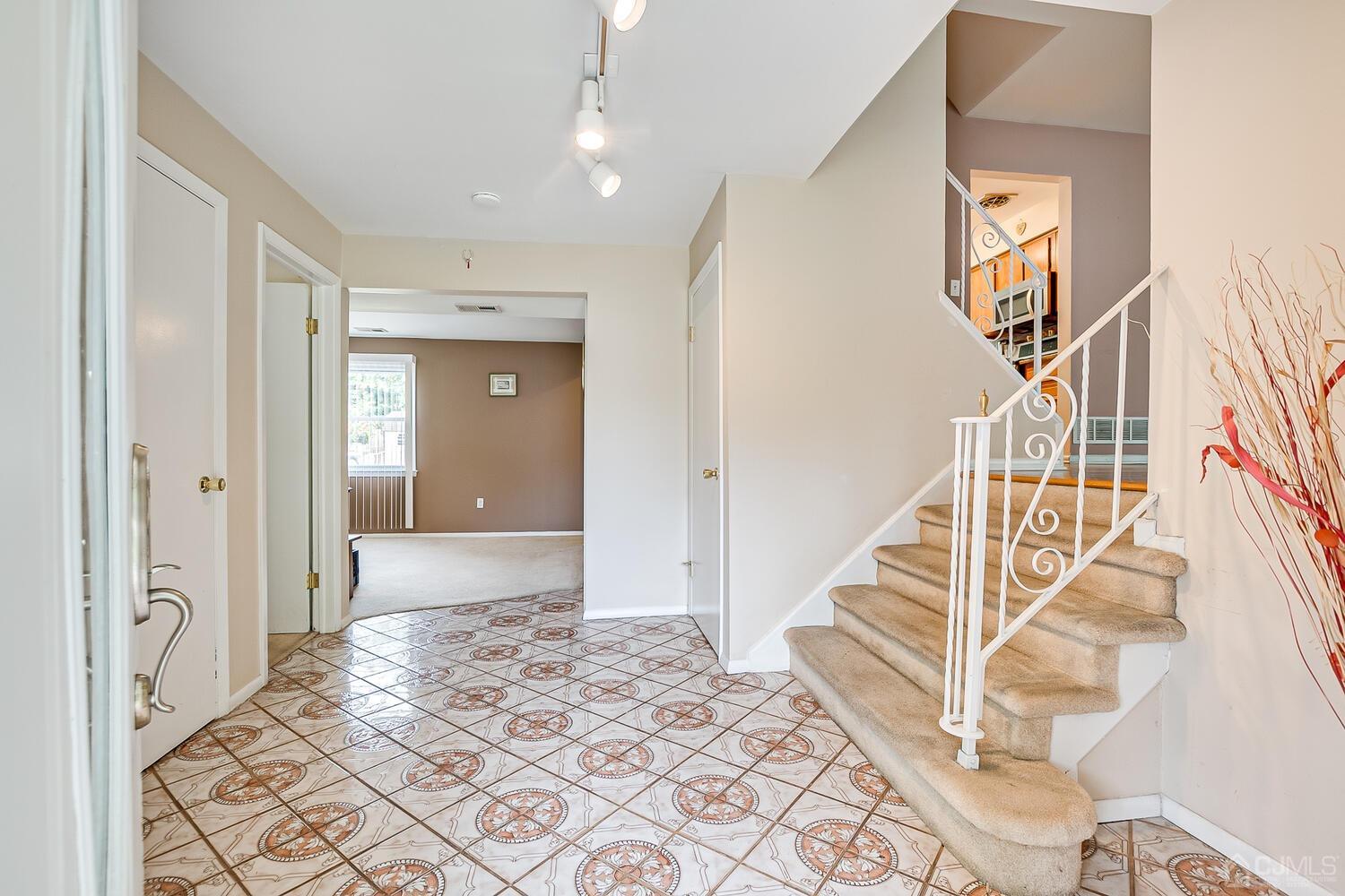 2 Julie Drive Edison, NJ 08820 - Photo 4 of 34 a view of a hallway with wooden floor and staircase