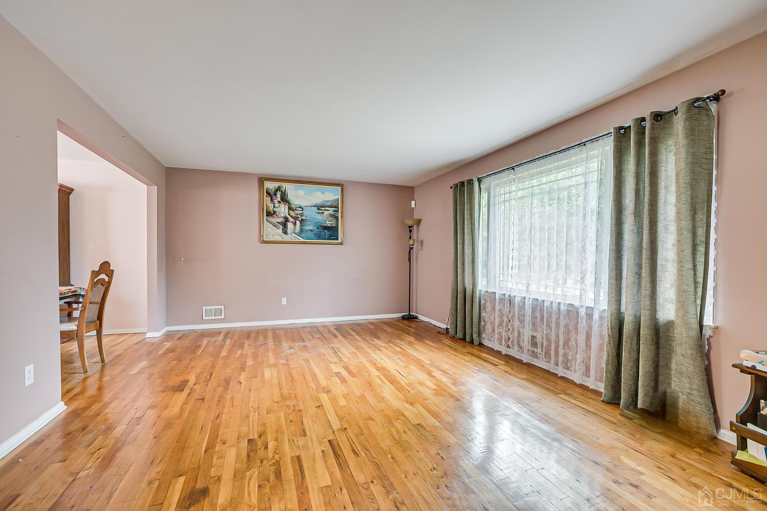 2 Julie Drive Edison, NJ 08820 - Photo 5 of 34 a view of empty room with wooden floor and fan