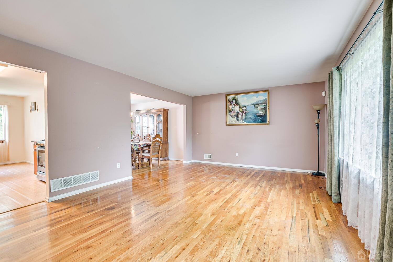 2 Julie Drive Edison, NJ 08820 - Photo 6 of 34 an empty room with wooden floor and windows