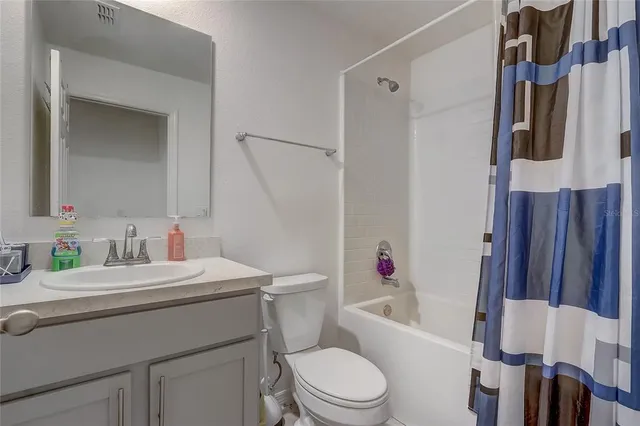 a bathroom with a sink toilet vanity and tub