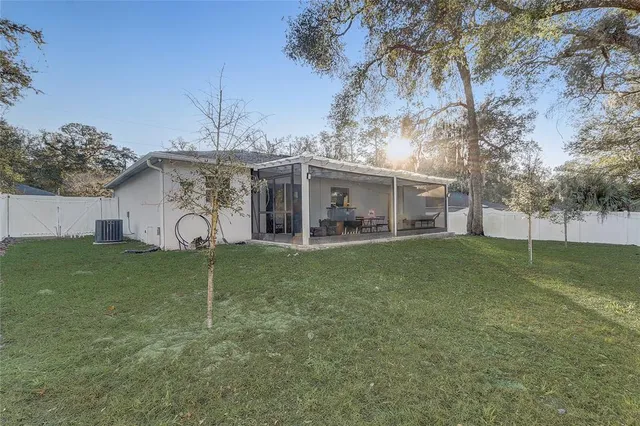 a view of a house with a backyard