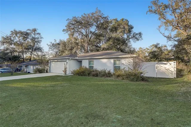 a front view of house with yard and trees