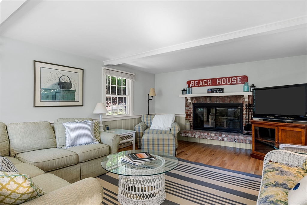 200 Hardings Beach Road Chatham, MA 02633 - Photo 12 of 24 a living room with furniture a flat screen tv and a fireplace
