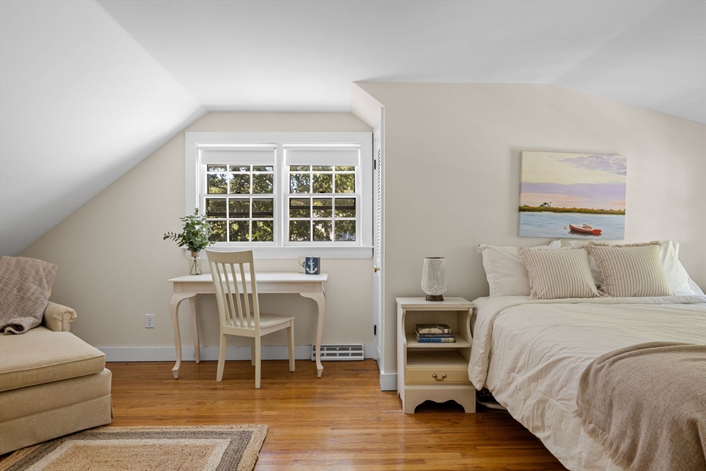 200 Hardings Beach Road Chatham, MA 02633 - Photo 19 of 24 a bedroom with a bed and a chair