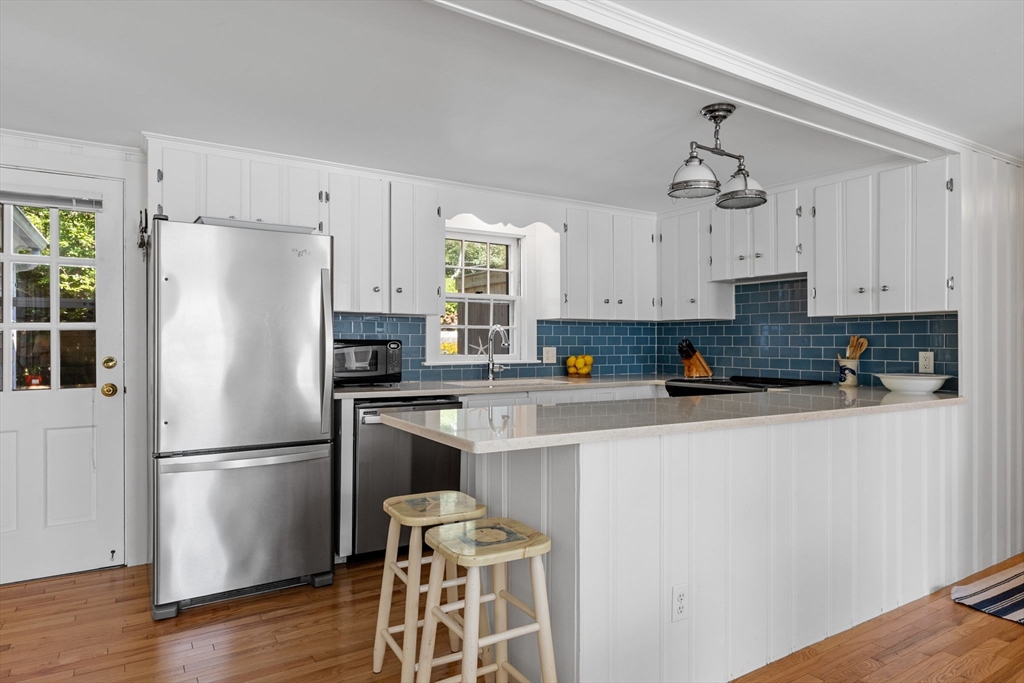 200 Hardings Beach Road Chatham, MA 02633 - Photo 8 of 24 a white refrigerator freezer sitting inside of a kitchen