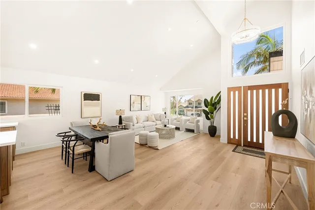 a living room with furniture kitchen view and a large window