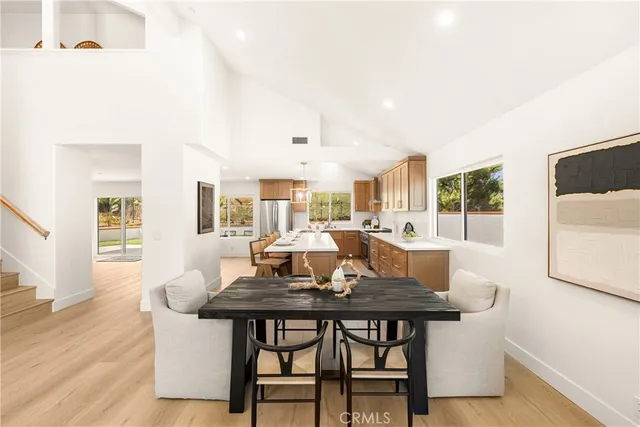 a kitchen with a stove a table and chairs in it