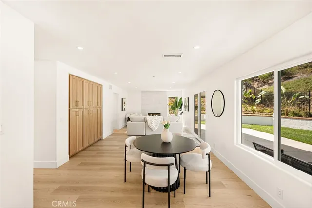 a living room with furniture a dining table and a window