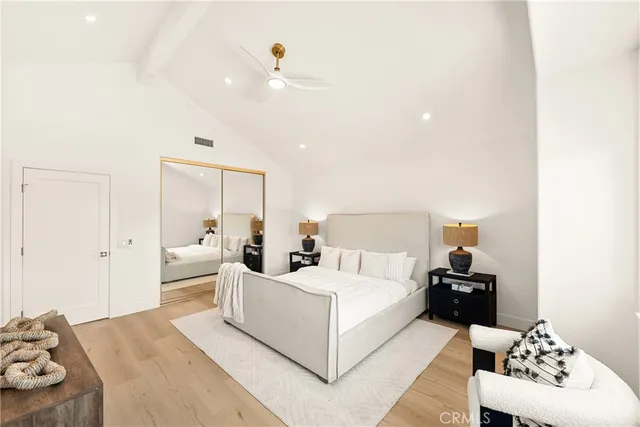 a bathroom with a granite countertop sink a toilet and a large mirror