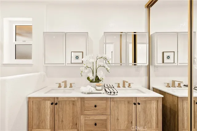 a bathroom with a toilet a sink a tub and mirror