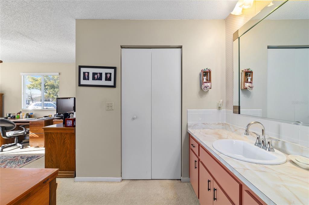 10921 Southwest 86th Court Ocala, FL 34481 - Photo 22 of 51 a bathroom with a sink a mirror and a window