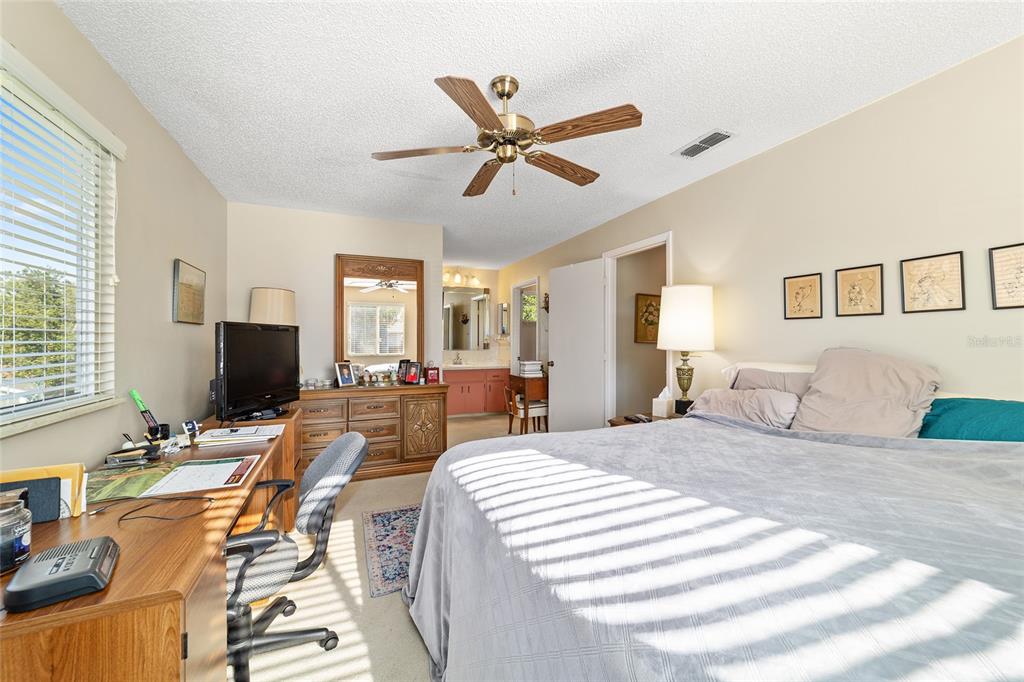 10921 Southwest 86th Court Ocala, FL 34481 - Photo 24 of 51 a bedroom with a bed and glass door