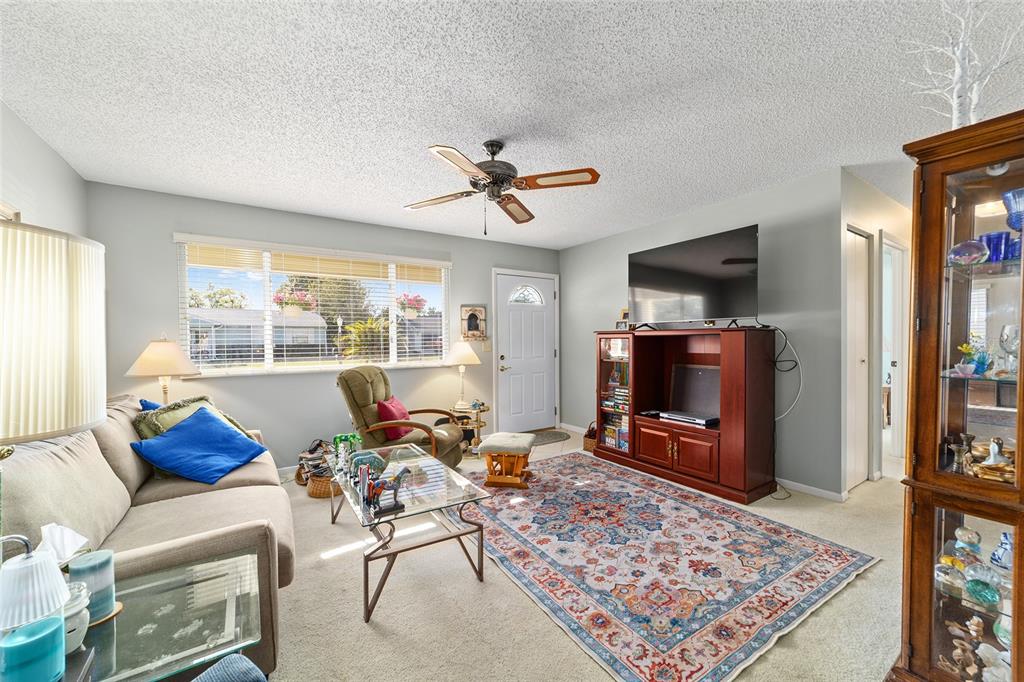 10921 Southwest 86th Court Ocala, FL 34481 - Photo 29 of 51 a living room with furniture and a flat screen tv