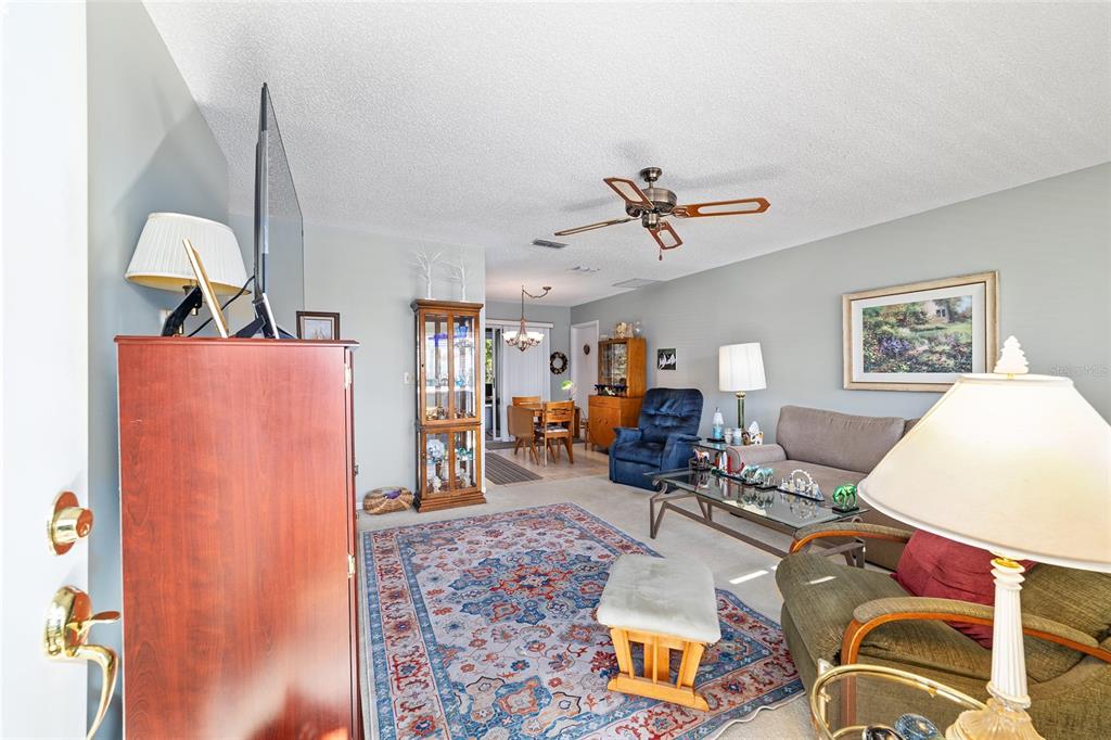 10921 Southwest 86th Court Ocala, FL 34481 - Photo 34 of 51 a living room with furniture a rug and gym equipment