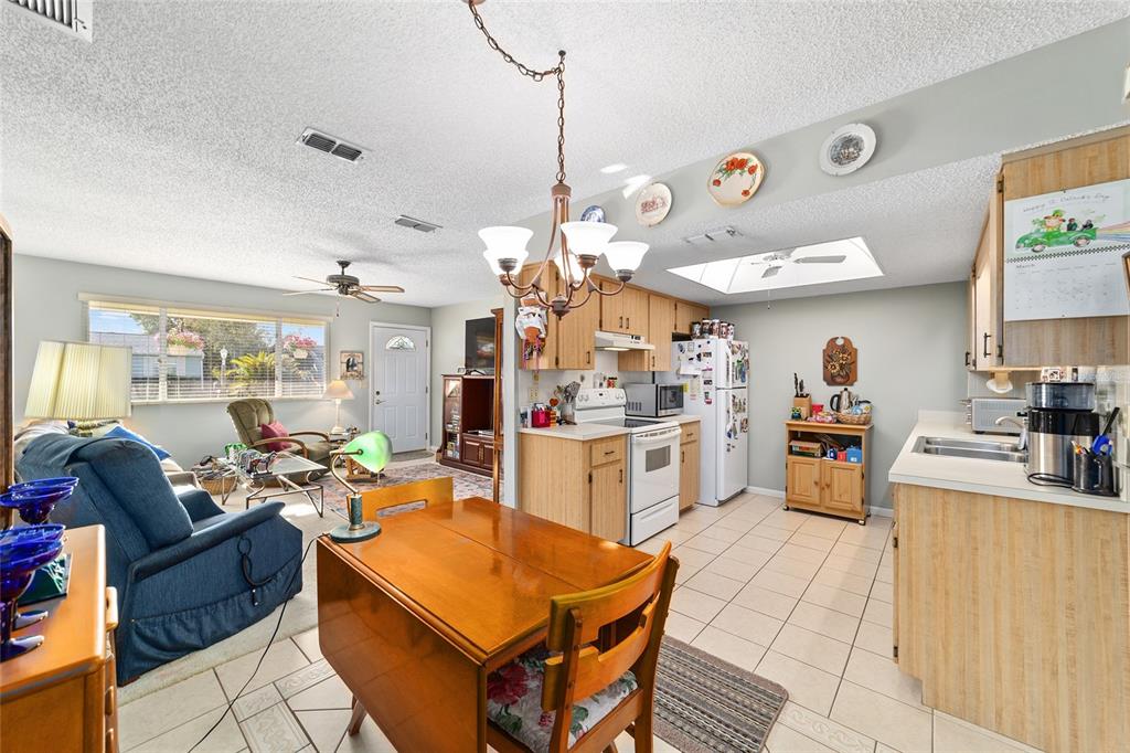 10921 Southwest 86th Court Ocala, FL 34481 - Photo 42 of 51 a room with stainless steel appliances kitchen island granite countertop furniture and a dining table