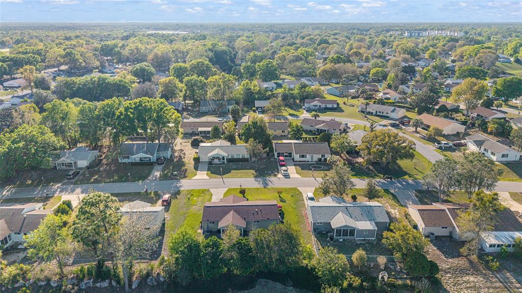 10921 Southwest 86th Court Ocala, FL 34481 - Photo 9 of 51 an aerial view of a house with a swimming pool outdoor seating and yard