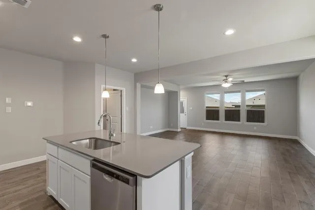 a kitchen with a sink and chandelier