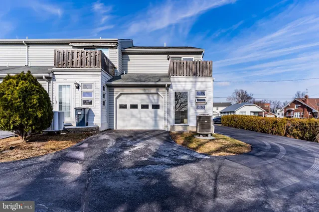 a view of a front of house with car parked