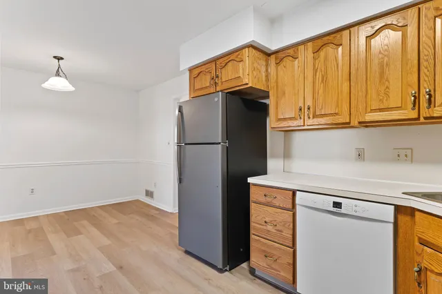 a kitchen with a refrigerator and cabinets