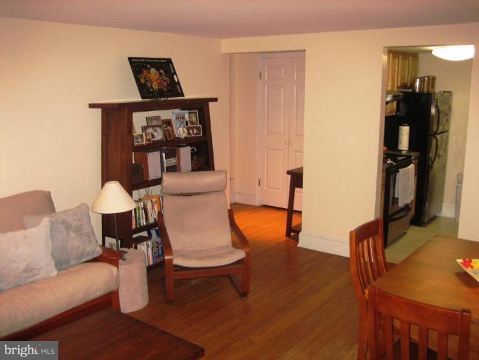 220 13th Street Southeast, Unit 5 Washington, DC 20003 - Photo 4 of 17 a living room with furniture a rug and a wall painting