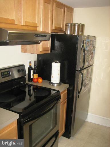 220 13th Street Southeast, Unit 5 Washington, DC 20003 - Photo 7 of 17 a kitchen with granite countertop a stove and a refrigerator