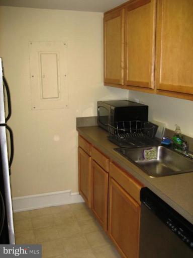220 13th Street Southeast, Unit 5 Washington, DC 20003 - Photo 8 of 17 a kitchen with stainless steel appliances granite countertop a sink a stove and a refrigerator