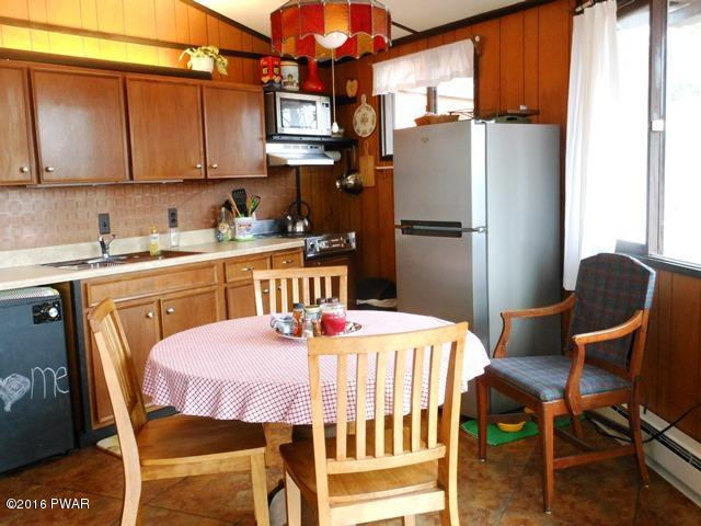 105 Ridge Road Hawley, PA 18428 - Photo 18 of 41 a dining table chair next to a window in a kitchen