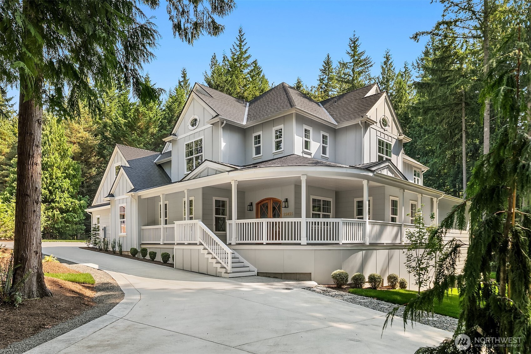 23403 Northeast Union Hill Road Redmond, WA 98053 - Photo 37 of 37 a view of a white house with large windows and a small yard