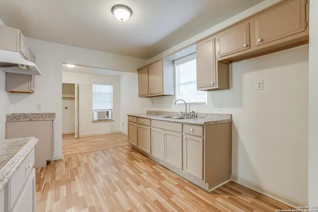 a kitchen with granite countertop white cabinets and white appliances