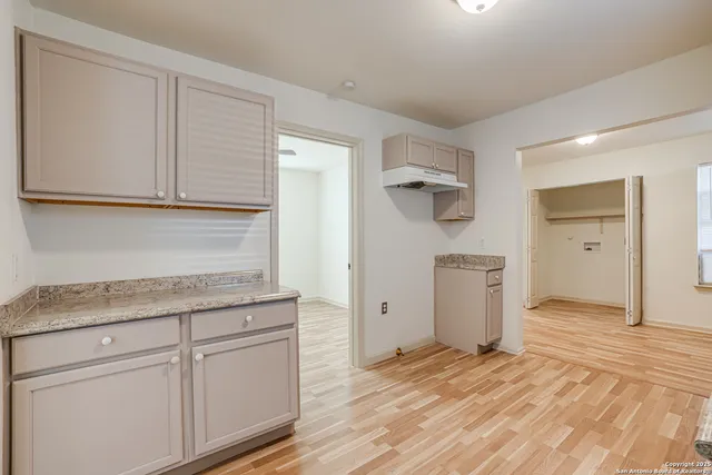 a kitchen with a refrigerator and cabinets