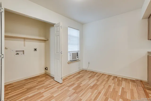 a view of a room with wooden floor and white doors