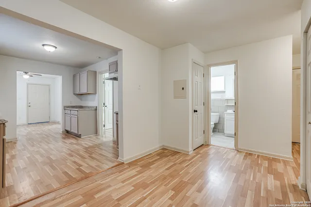 a view of a kitchen with wooden floor and a sink