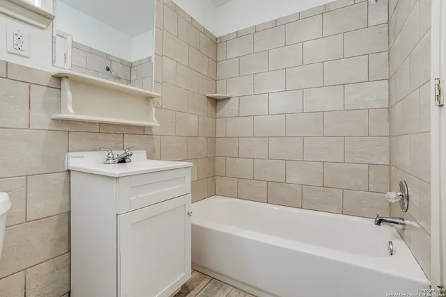 a bathroom with a sink a vanity and bathtub