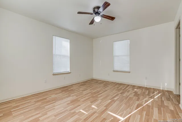 a view of empty room with ceiling fan