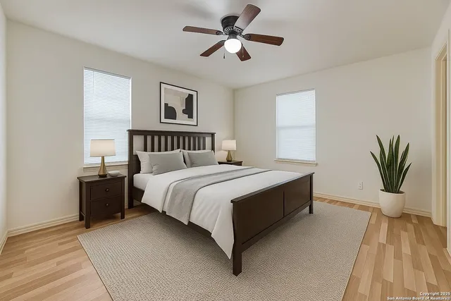 a bedroom with a large bed and a chandelier