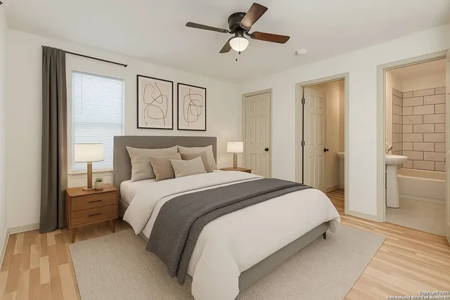 a bedroom with a bed and a painting on the wall