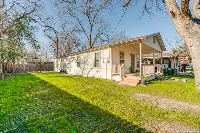 a view of a house with a yard patio and swimming pool