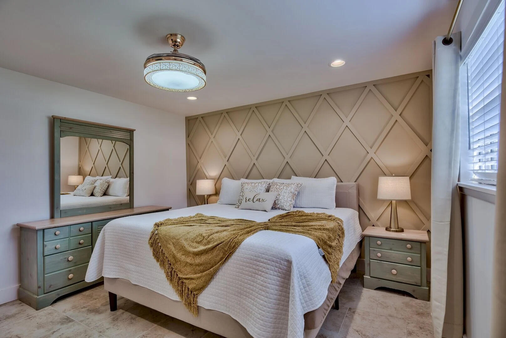 a bedroom with a bed and a mirror