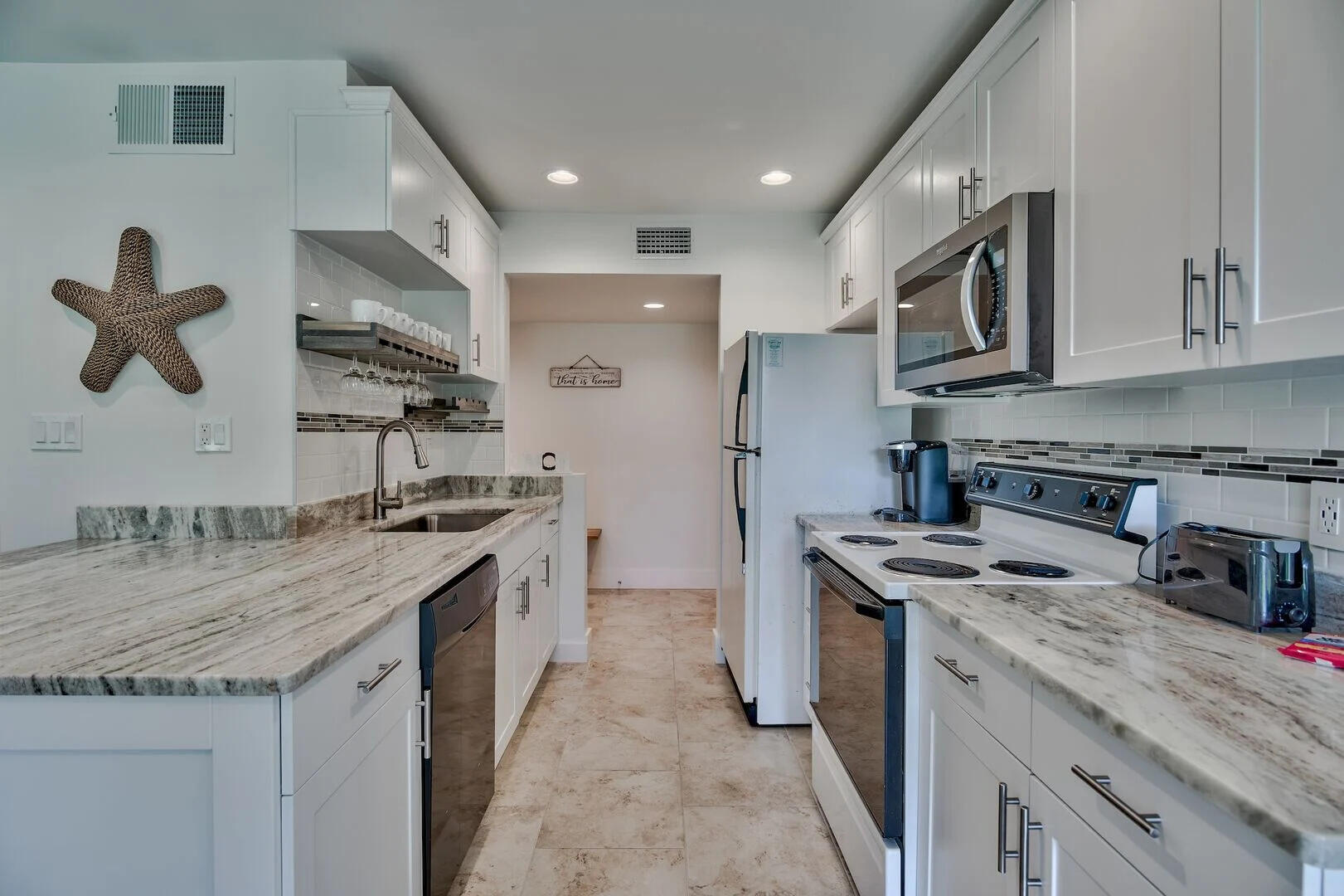 159 Sunset Bay, Unit 23A Miramar Beach, FL 32550 - Photo 14 of 31 a kitchen with stainless steel appliances granite countertop a sink stove and refrigerator