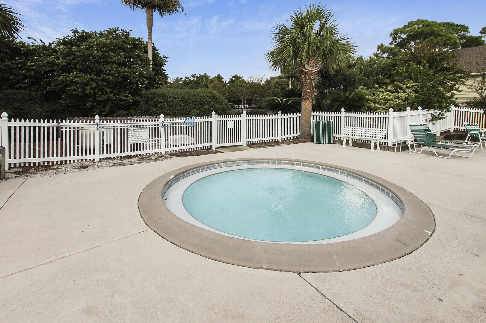 159 Sunset Bay, Unit 23A Miramar Beach, FL 32550 - Photo 26 of 31 a view of a swimming pool and trees in the background