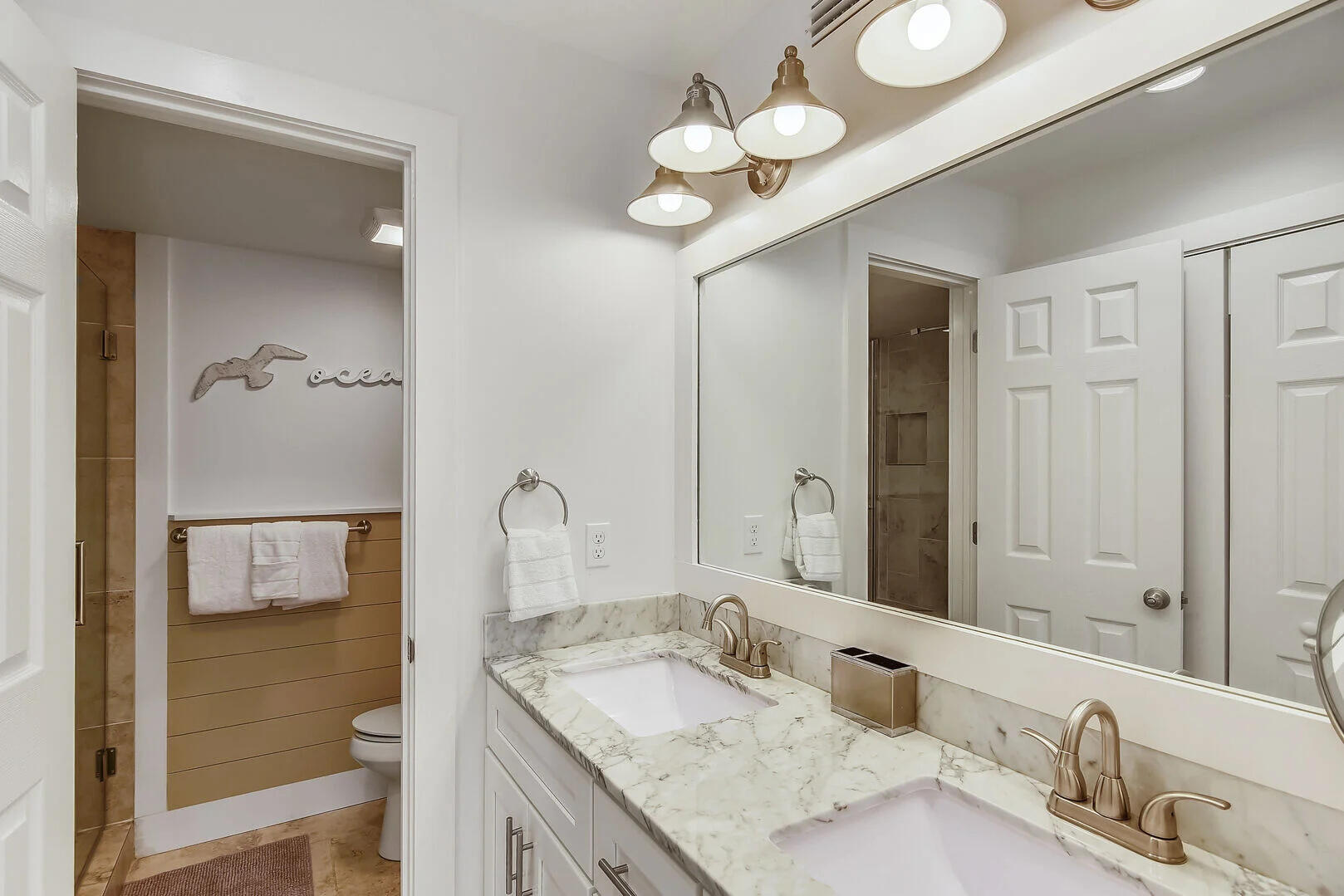 159 Sunset Bay, Unit 23A Miramar Beach, FL 32550 - Photo 3 of 31 a bathroom with a granite countertop sink a toilet and a mirror
