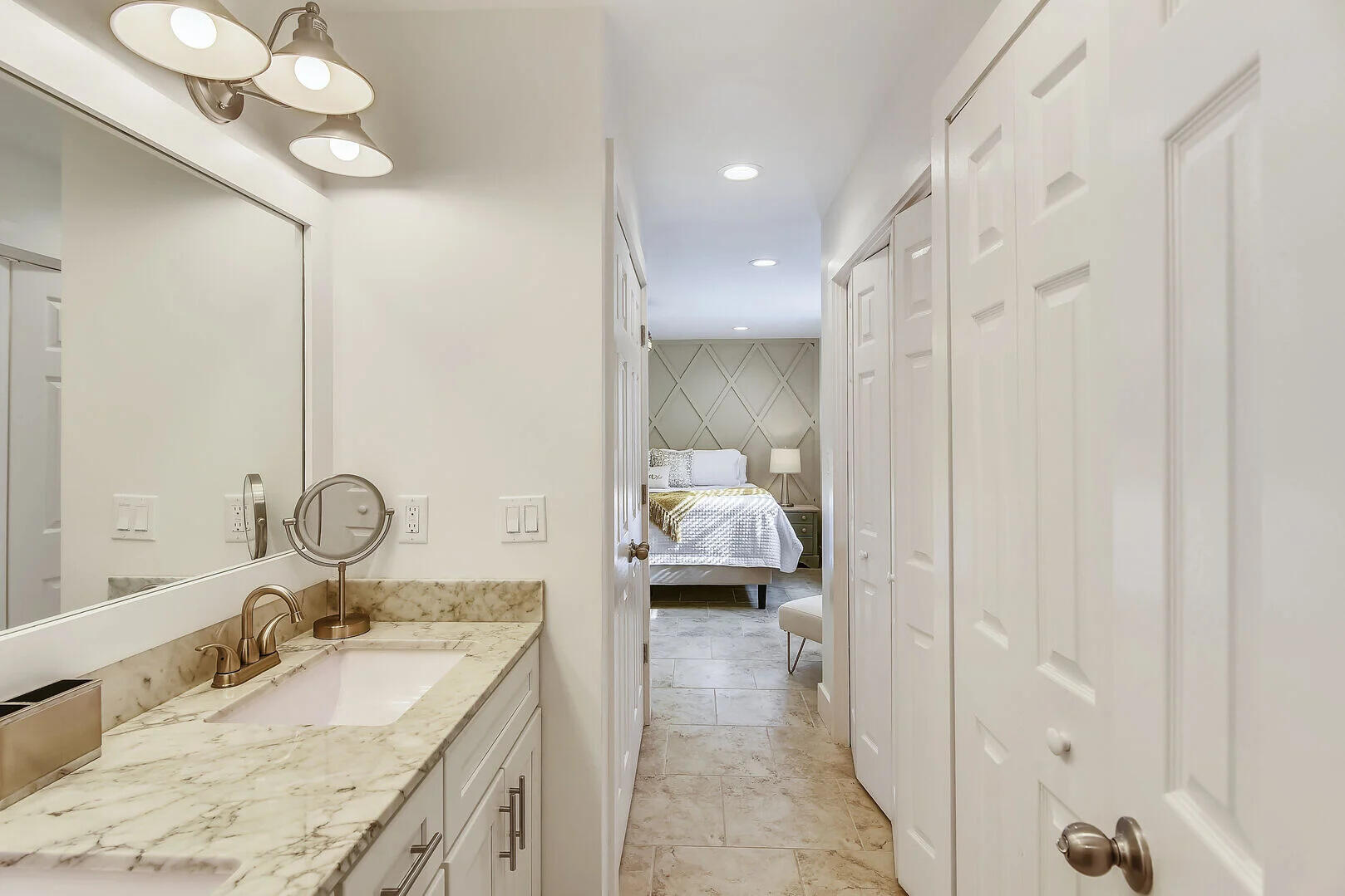 159 Sunset Bay, Unit 23A Miramar Beach, FL 32550 - Photo 4 of 31 a en suite bathroom with a granite countertop sink a mirror and shower