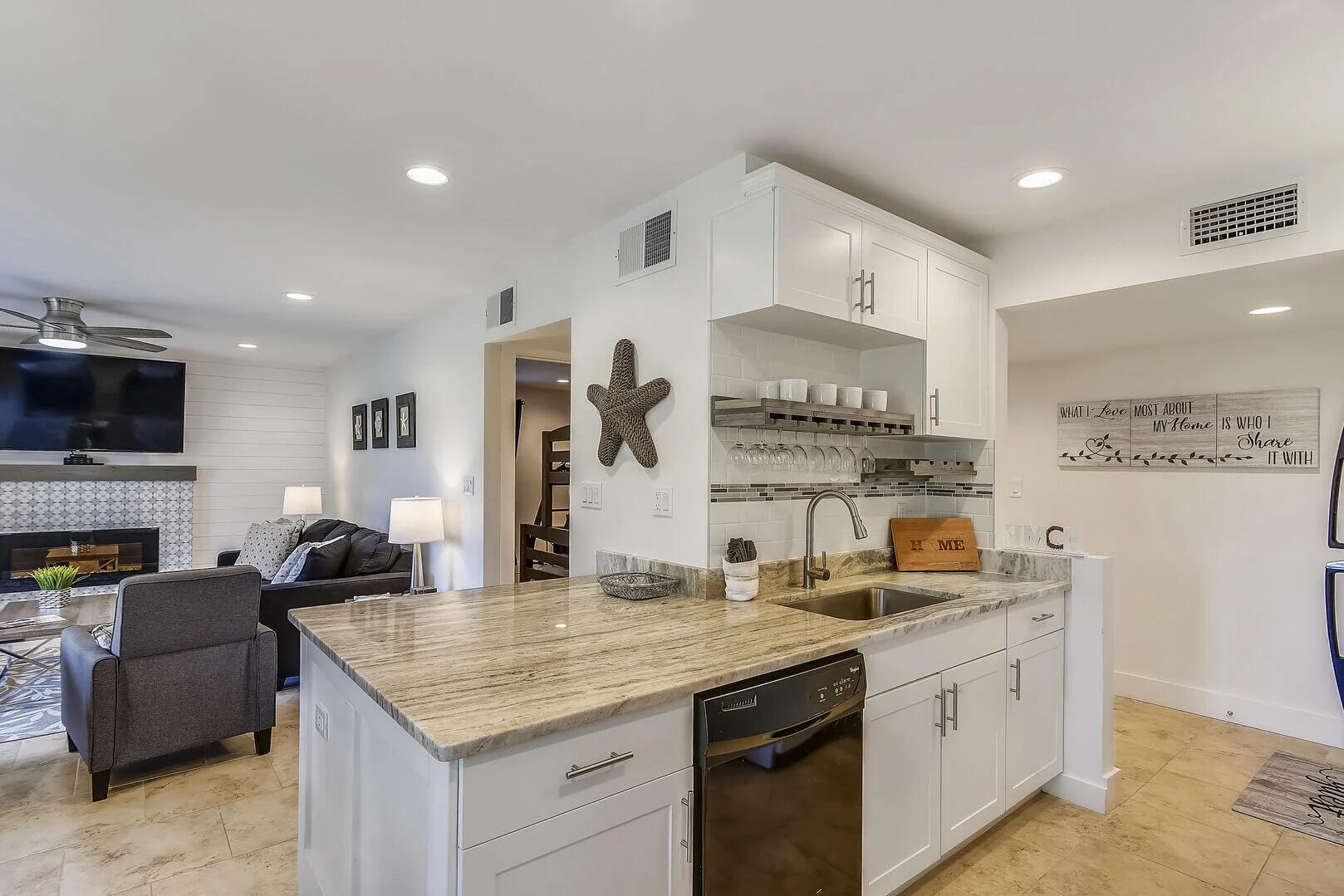 159 Sunset Bay, Unit 23A Miramar Beach, FL 32550 - Photo 5 of 31 a kitchen with granite countertop a sink and a stove top oven with wooden floor