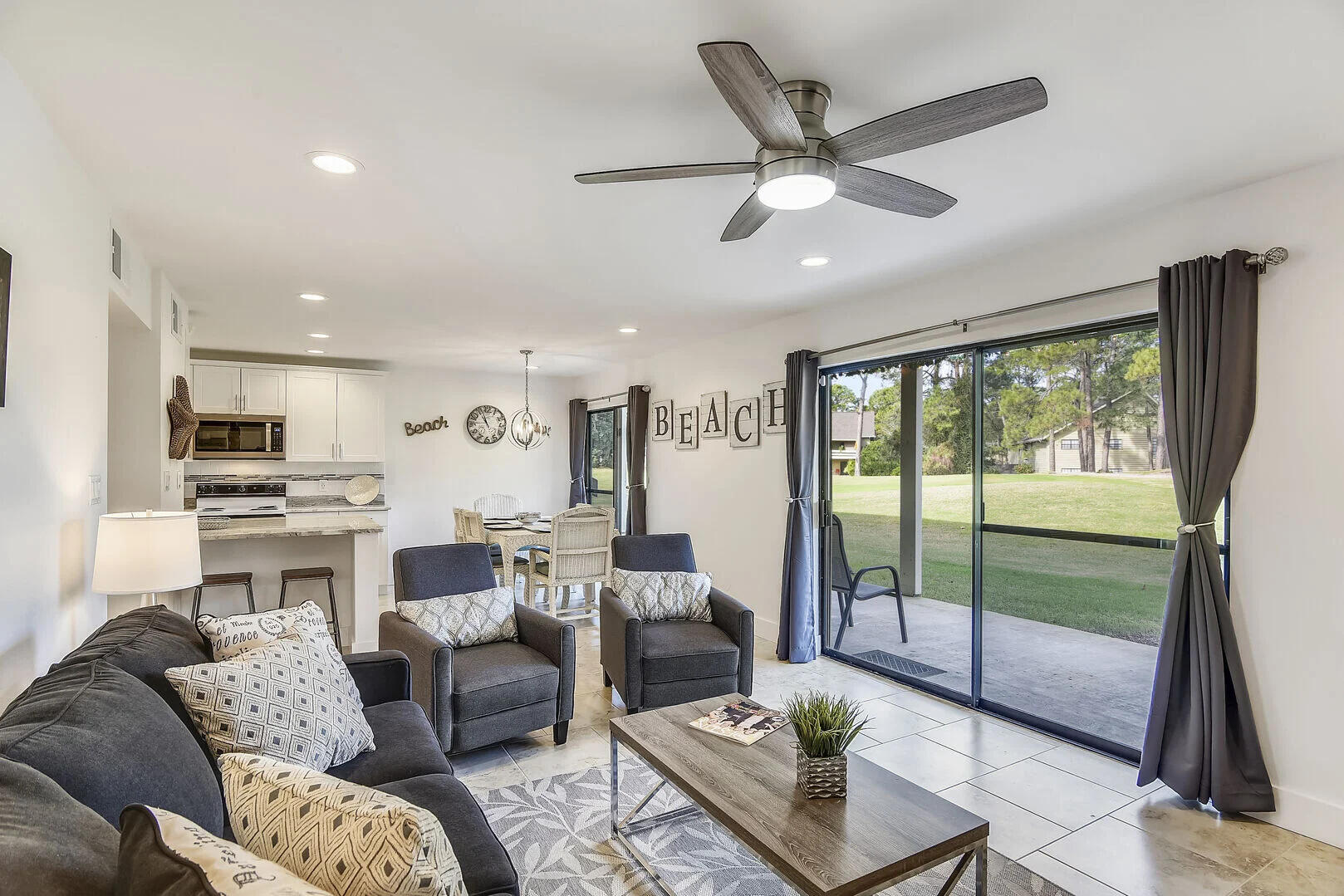 159 Sunset Bay, Unit 23A Miramar Beach, FL 32550 - Photo 6 of 31 a living room with furniture kitchen view and a large window