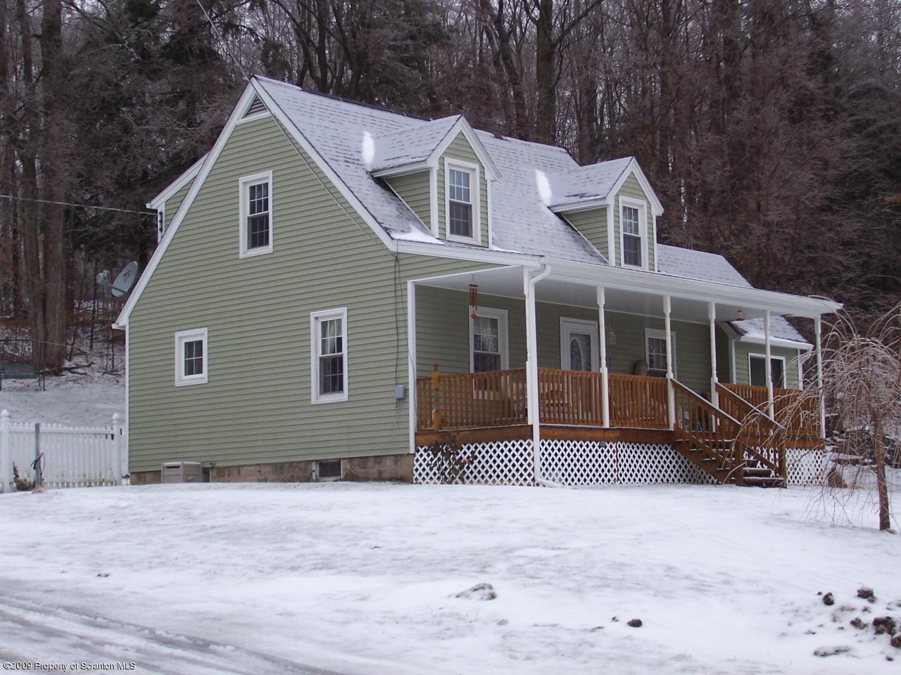 6456 R R, Unit 6 Montrose, PA 18801 - Photo 2 of 10 a front view of a house with a garden