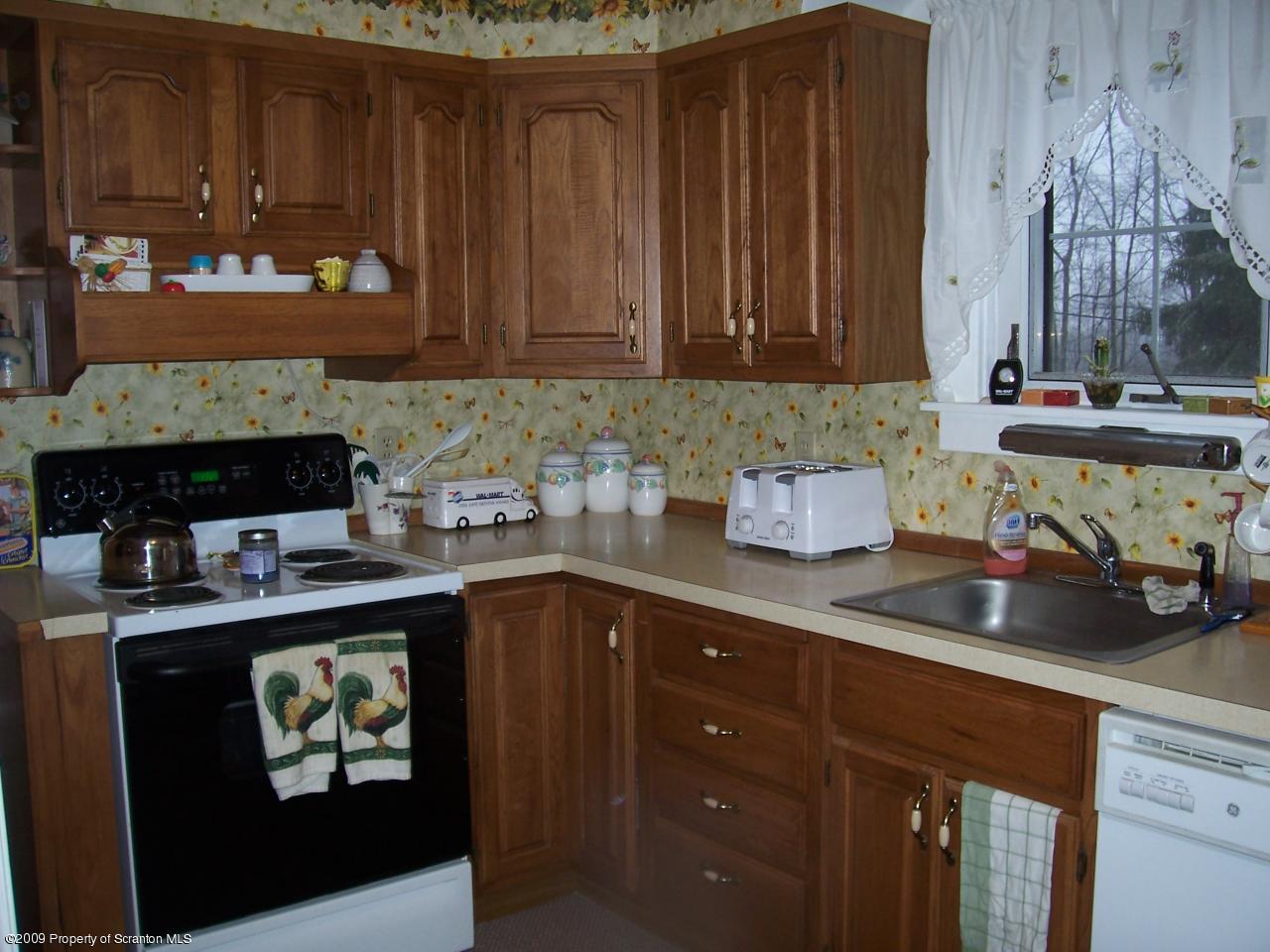 6456 R R, Unit 6 Montrose, PA 18801 - Photo 6 of 10 a kitchen with stainless steel appliances granite countertop a sink dishwasher stove and cabinets with wooden floor
