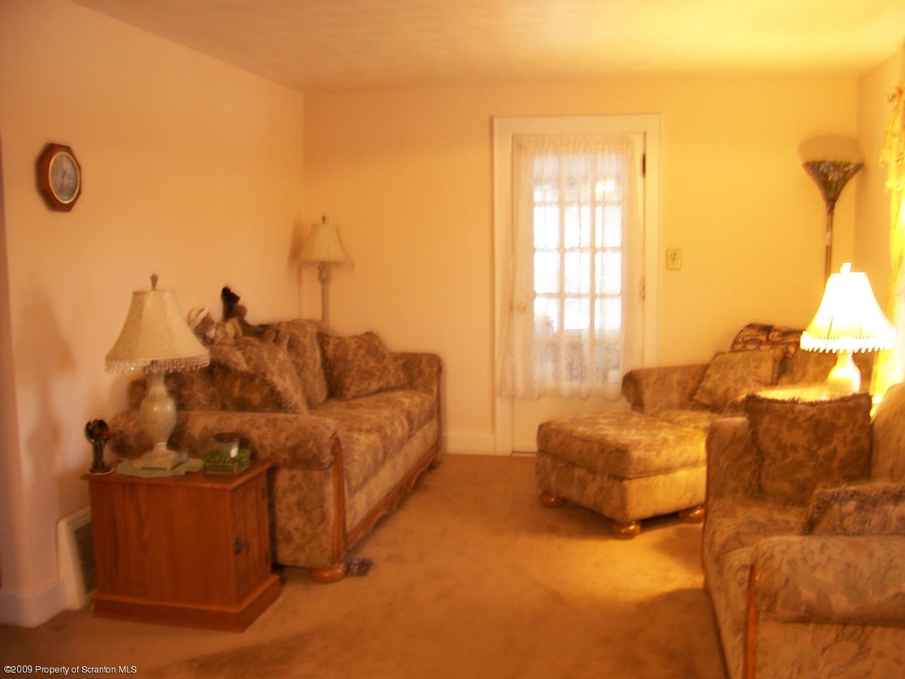 6456 R R, Unit 6 Montrose, PA 18801 - Photo 8 of 10 a living room with furniture and a window