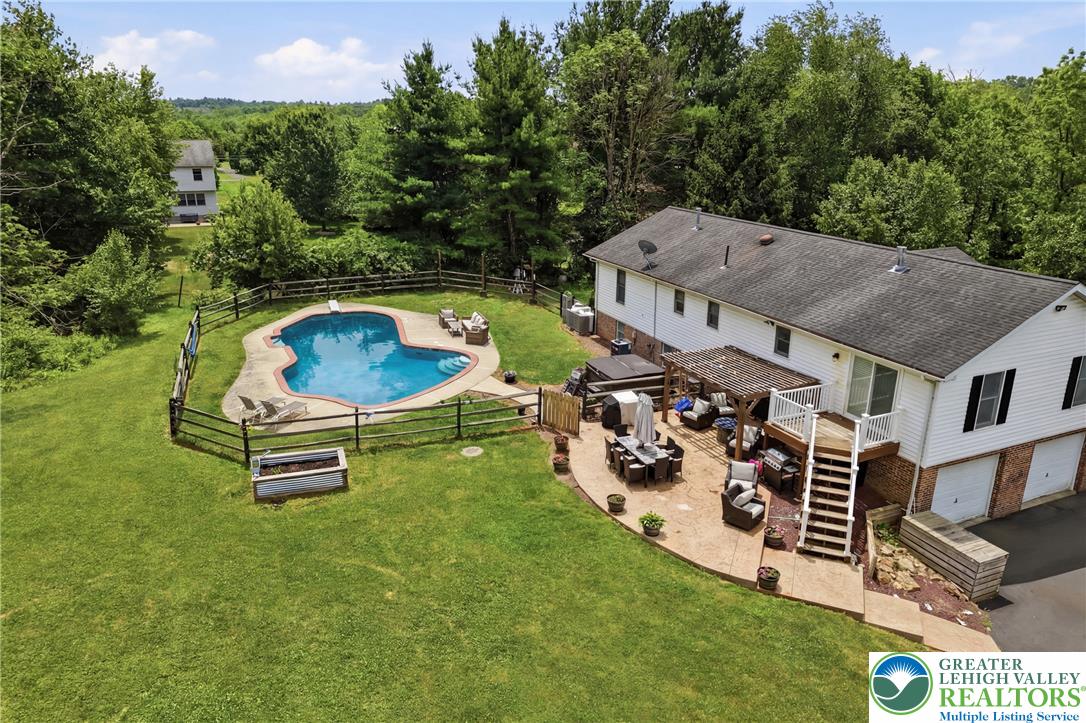 732 Bushkill Center Road Nazareth, PA 18064 - Photo 31 of 43 A spacious backyard oasis with a fenced pool and expansive patio ideal for outdoor gatherings.