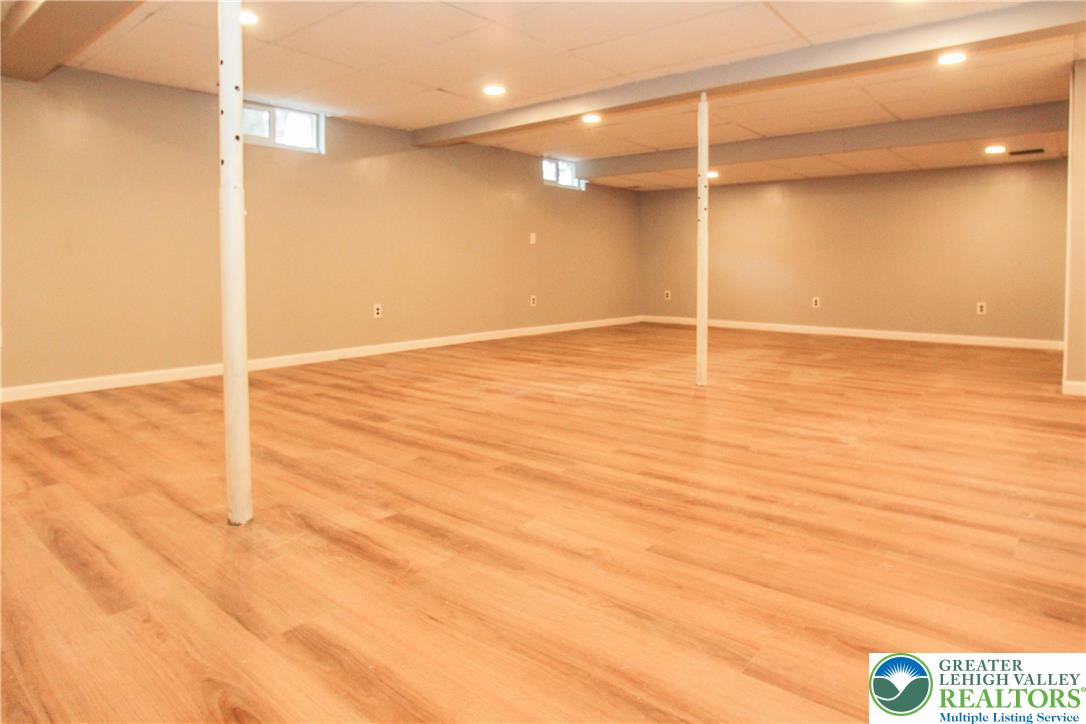 492 Filetown Road Nazareth, PA 18064 - Photo 25 of 30 A spacious, newly finished basement features warm wood-toned flooring and recessed lighting throughout.
